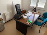 a desk with a chair and a laptop on top of it