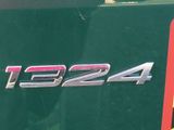 a close up of a green truck with a red stripe on it