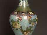 a vase that is sitting on a table with a black background