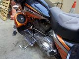 a black and orange motorcycle parked in a garage