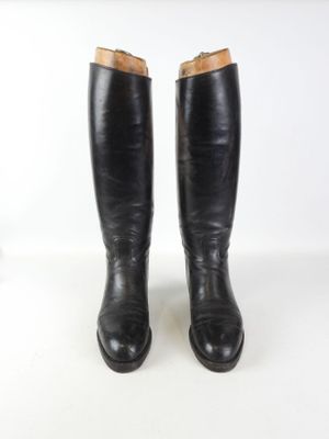 pair of black leather riding boots on a white background