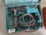 a blue box with a corded drill and a corded hammer in it