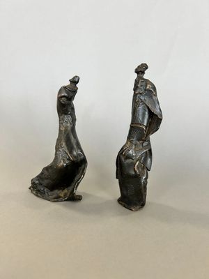 pair of bronze figurines of a man and a woman