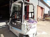 a fork lift truck parked in front of a building