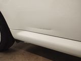 a close up of a white car parked in a garage