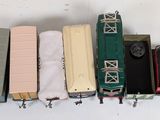 a lot of toy train cars that are lined up together