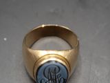 an image of a gold ring with a blue stone in the center