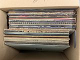 a cardboard box full of old records in it