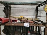 many tools on a wooden shelf in a garage