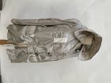 a silver jacket with a wooden handle on a white surface