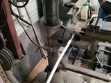 a machine that is working on a piece of wood