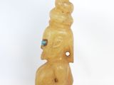 statue of a woman with a hat on her head and a blue eye