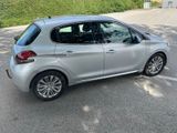 a small silver car parked in a parking lot
