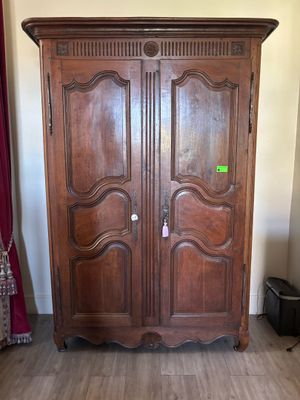 an image of a large wooden armoire in a living room