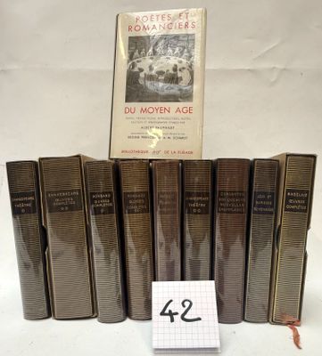 several books are stacked on top of each other on a table