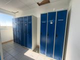 several blue lockers are lined up in a row in a room