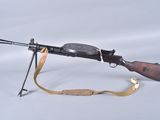 an old machine gun with a sling on a white background