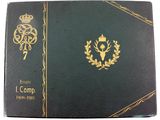 a green book with gold trim and a crown on it