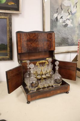 a wooden box with a glass set inside of it