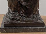 a statue of a woman sitting on top of a table