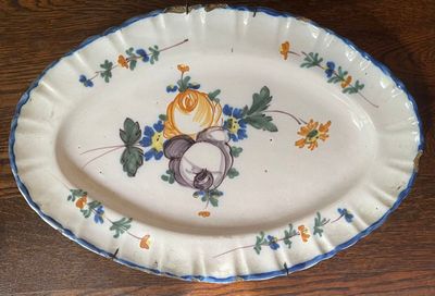 a plate with a bird and a flower design on it