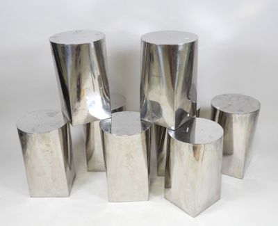 several pieces of silver metal on a white surface