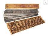 several old books are lined up on a white surface