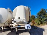 two large white tanks sitting on the back of a truck