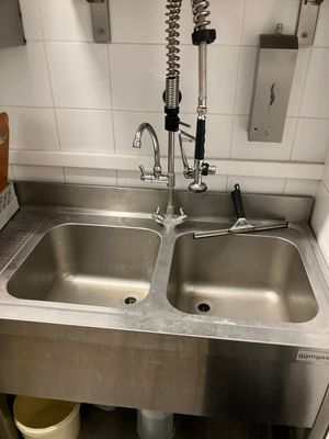 two sinks in the kitchen with a faucet on the counter