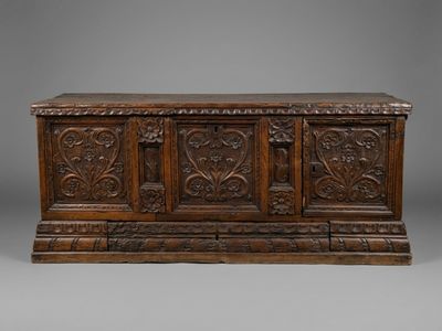 an oak chest with carved panels and carvings