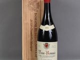 a bottle of wine sitting next to a wooden box