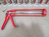 a red pipe cutter on a table next to cans of paint