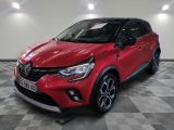 a red toyota c - hr suv parked in a showroom