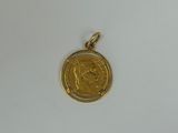 a close up of a gold coin on a white surface