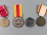 three medals are sitting on a table next to each other