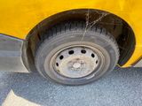 a close up of a car tire with a spider web attached to it