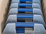 boxes of blue and gray boxes are stacked in a cardboard box