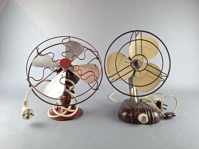 two small metal fans that are sitting on top of each other