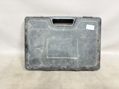 an old tool case with a tag on it sitting on a table