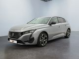 a silver car is parked in a room with a white wall