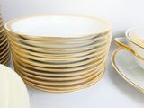 a lot of plates and cups on the table