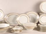 a lot of plates and bowls on the table