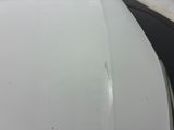 a close up of the hood of a white car