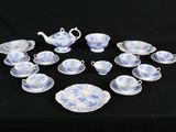 a lot of blue and white china on a black table