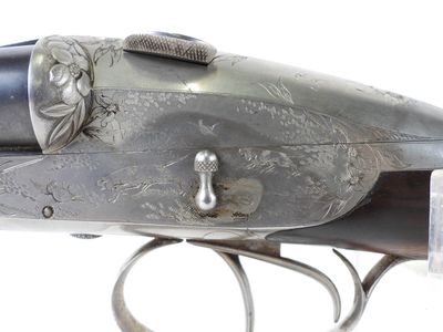 an old gun with a silver body and a silver handle
