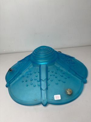 a blue plastic bird feeder on a white counter