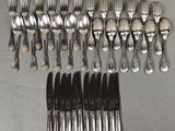 a lot of forks and spoons that are on the table