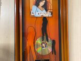 a picture of a picture of a woman hanging on a wall