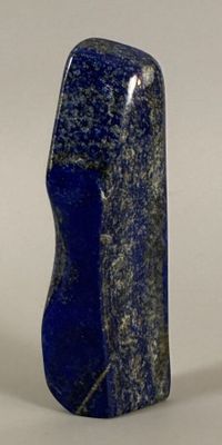 a blue stone that is sitting on a white surface