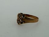 an image of a gold ring with black stones